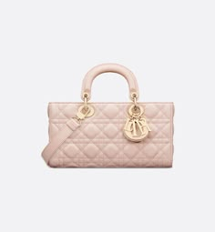 The Lady D-Joy bag epitomizes Dior's vision of elegance and beauty. Refined and sleek, the timeless style showcases the iconic streamlined aesthetic of the Lady Dior line. Crafted in powder pink lambskin with Cannage stitching, it is enhanced by pale gold-finish metal D.I.O.R. charms embellishing its silhouette. Featuring one removable chain shoulder strap and another adjustable and removable leather shoulder strap, the medium Lady D-Joy bag can be carried by hand, worn over the shoulder or cros Sac Lady Dior Medium, Lady D Joy Bag, Galaxy Stuff, Lady D, Lady Dior Handbag, Dior Book Tote, Small Lady, Dior Handbags, Wallet Pouch