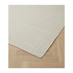 a white rug on top of a wooden floor with an area rug in the middle