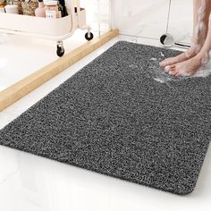 a person standing on top of a bathroom rug