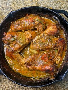 some chicken is cooking in a skillet on the counter