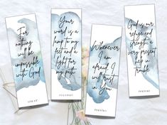 three watercolor bookmarks with handwritten text on them