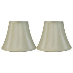 two white lampshades sitting next to each other