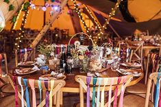 the tables are set up with colorful ribbons and place settings for guests to sit at