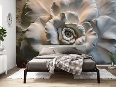 a large white flower sitting on top of a bed