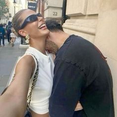 a man and woman kissing on the street