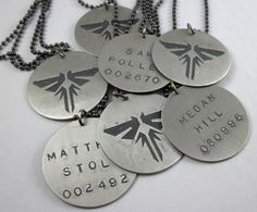 six personalized necklaces on a white surface