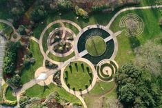 an aerial view of a circular garden in the middle of a park