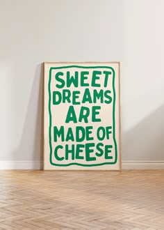 a green and white sign that says sweet dreams are made of cheese on the floor