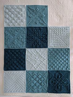 a blue and white quilt with squares on it