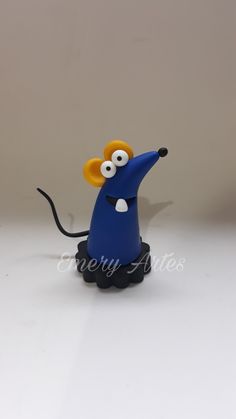 a blue toy mouse with eyes on it's head