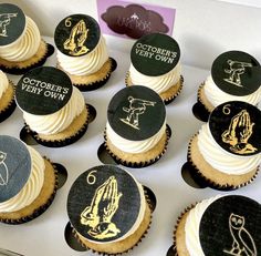 cupcakes with black and white frosting decorated with gold designs on each one