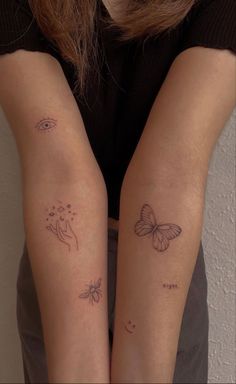 two people with tattoos on their arms, one has a butterfly and the other has a flower