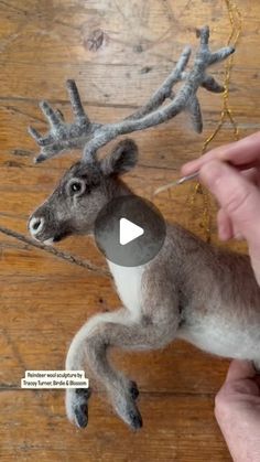 someone is making a reindeer ornament out of felt