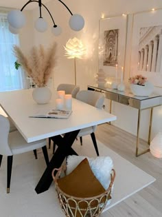 a white dining room table surrounded by chairs