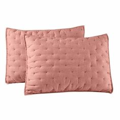 two pink pillows sitting next to each other