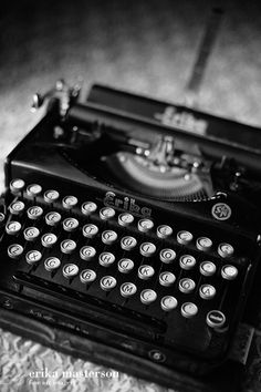 an old fashioned typewriter sitting on top of a table