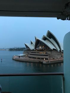 the sydney opera house is lit up at night