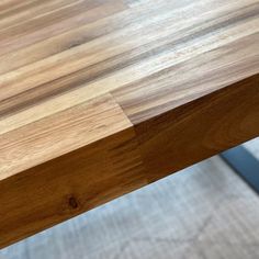 a close up view of a wooden table with no one on it or in the background