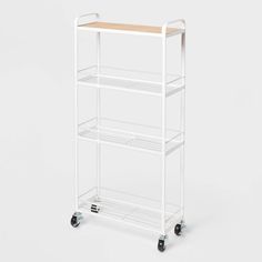 a white rolling cart with two shelves on wheels