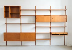 an empty room with shelves and drawers on the wall