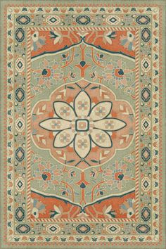 an orange and blue rug with floral designs on the center, surrounded by other decorative elements