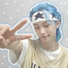 a person with blue hair making the peace sign