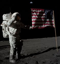 an astronaut standing on the moon with his arms outstretched in front of an american flag