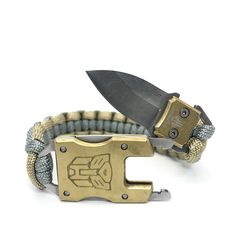 a gold and gray bracelet with a knife on it