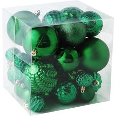 a clear box filled with green christmas ornaments