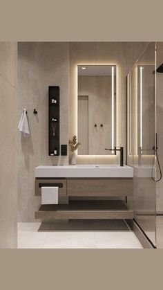 a bathroom with a sink, mirror and lights on the wall above it's counter