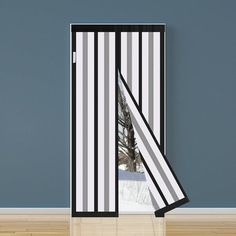 an open door with a black and white stripe pattern on it, in front of a blue wall