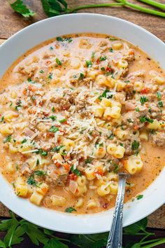 a white bowl filled with pasta and meat soup