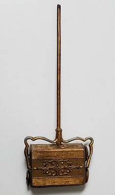 an old fashioned toothbrush holder hanging on the wall