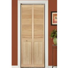 the interior door is made from wood and has shutters that match with the wall color