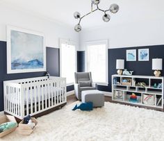 a baby's room with blue walls and white carpet