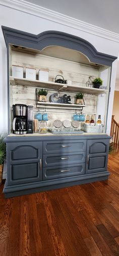 an old fashioned kitchen with blue cabinets and wood flooring is displayed in this image