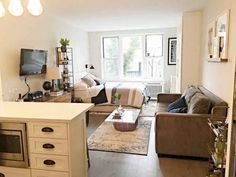 a living room filled with furniture and a flat screen tv on top of a wall