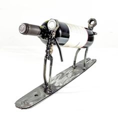 a wine bottle holder on a snowboard with a corkscrew attached to it