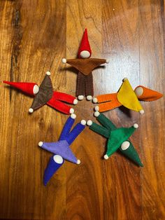 several small wooden toy airplanes sitting on top of a wooden floor