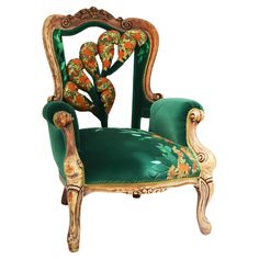 an ornately decorated green chair with orange flowers on the armrests and back