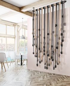 a living room with a large wall sculpture made out of wood sticks and metal rods