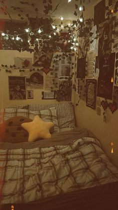 a bed room with a neatly made bed and lots of pictures on the wall