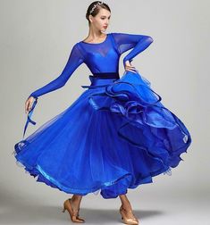 a woman in a blue dress is dancing