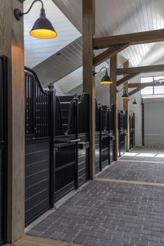 the inside of a stable with stalls and lights