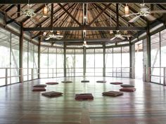 an empty room with wooden floors and large windows