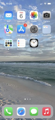 an iphone screen with icons on it and the beach in the backgroung