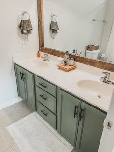 a bathroom with two sinks and a large mirror