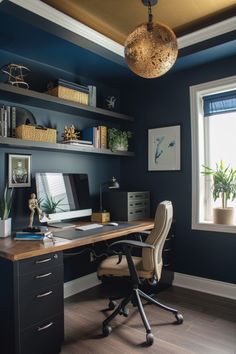 a home office with dark blue walls and wooden floors, built in shelving units