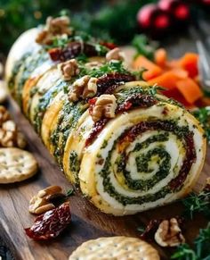 a close up of food on a cutting board with crackers and vegetables in the background