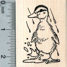 a rubber stamp with a duck on it's body and drops of water coming out of its beak